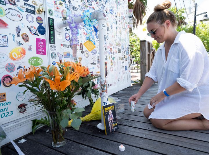 Meagan Bryon of Hoboken, New Jersey, places a "lost shaker of salt" at an impromptu memorial for Jimmy Buffett outside the singer-songwriter's Shrimpboat Sound recording studio on Saturday in Key West, Florida.