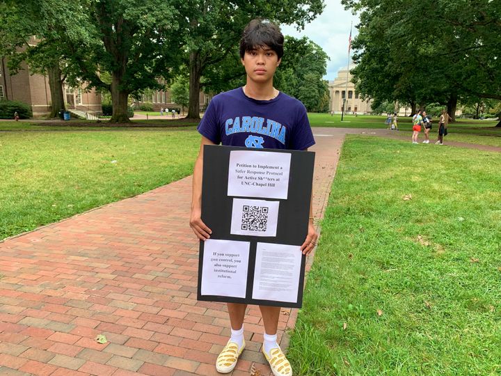 Micah Baldonado, a biomedical engineering student from Charlotte, N.C., holds his petition for improvements to the UNC-Chapel Hill active shooter response protocol on campus, Wednesday, Aug. 30, 2023, days after a shooting at the university.