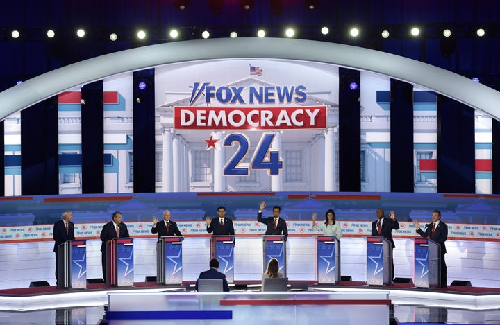 With the exception of former Arkansas Gov. Asa Hutchinson and former New Jersey Gov. Chris Christie, Republican presidential candidates (3rd L-R) former Vice President Mike Pence, Florida Gov. Ron DeSantis, Vivek Ramaswamy, former U.N. Ambassador Nikki Haley, Sen. Tim Scott (S.C.) and North Dakota Gov. Doug Burgum raise their hands to say they would support Donald Trump as the party's presidential nominee during the first debate of the GOP primary season hosted by FOX News at the Fiserv Forum on Aug. 23 in Milwaukee, Wisconsin.