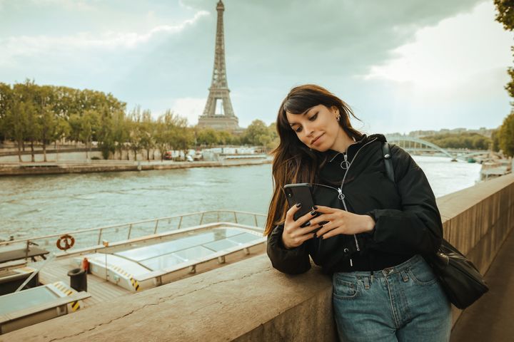 Young woman using smartphone in Paris