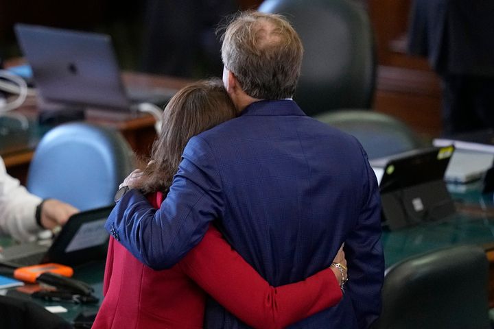 Texas Attorney General Ken Paxton, right, is hugged by his wife, state Sen. Angela Paxton (R-McKinney).
