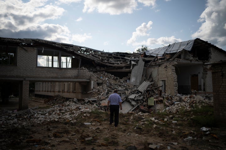 Oleksandr Pishchyk, a school director, stands in front of the school library that was destroyed by shelling in Kupiansk, Ukraine, on Aug. 23.