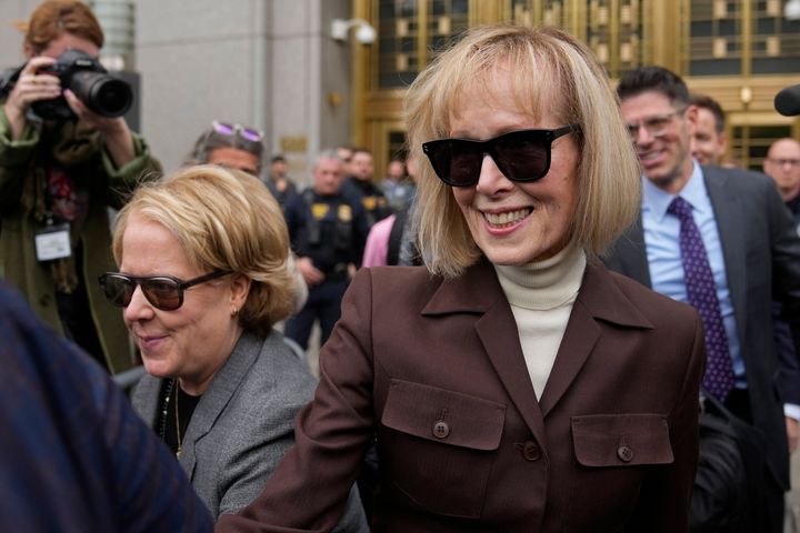 E. Jean Carroll (right) walks out of Manhattan federal court in May.