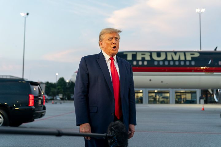Former President Donald Trump speaks with reporters before departure from Hartsfield-Jackson Atlanta International Airport in August.