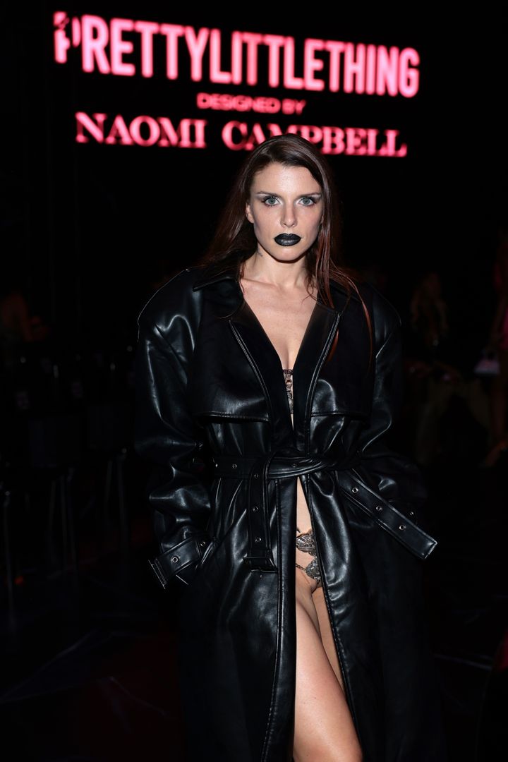 Julia Fox attended the PrettyLittleThing x Naomi Campbell runway show in a floor-length black trenchcoat. 
