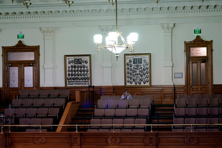 A woman attends the impeachment trial for Texas Attorney General Ken Paxton from the gallery in the Senate Chamber at the Texas Capitol. Tickets are required to enter the chamber, but attendance has been light.