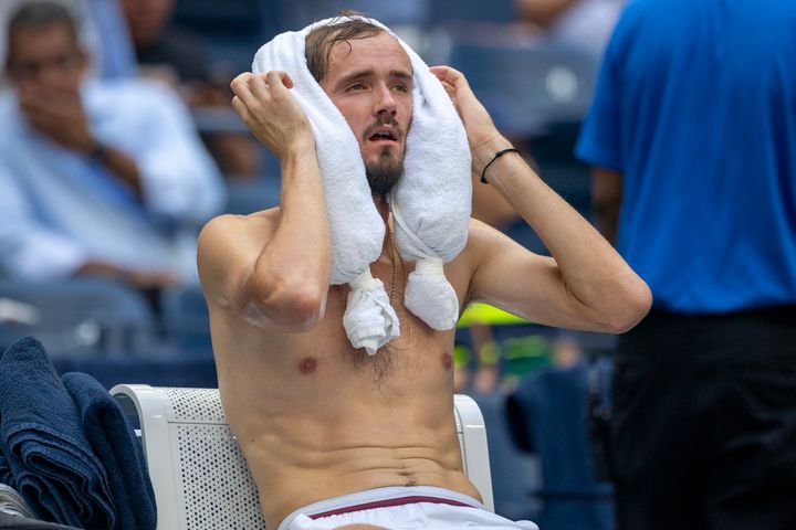 Daniil Medvedev of Russia cools off with an ice pack between sets two and three during his match against Andrey Rublev of Russia.