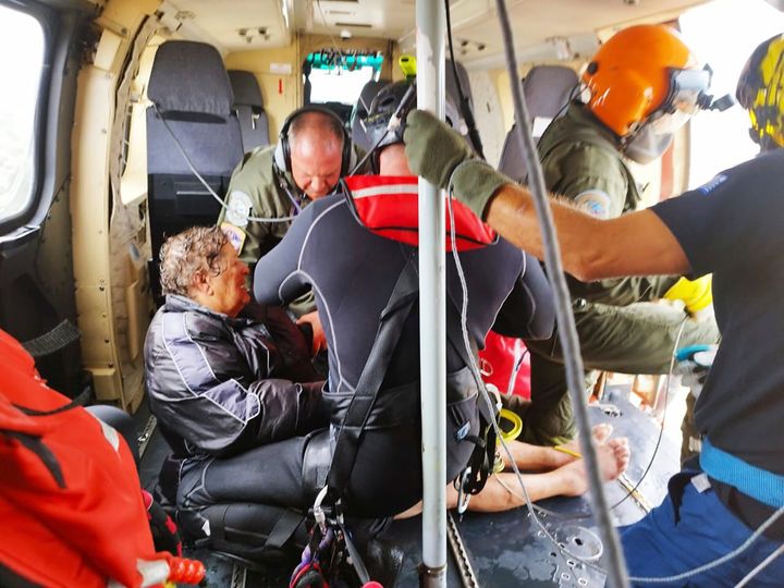 In this photo provided by the Ministry of Climate Crisis & Civil Protection, rescuers by helicopter save a woman from floodwaters in the village of Agia Triada, near Karditsa, Thessaly region, central Greece, on Sept. 7, 2023. 