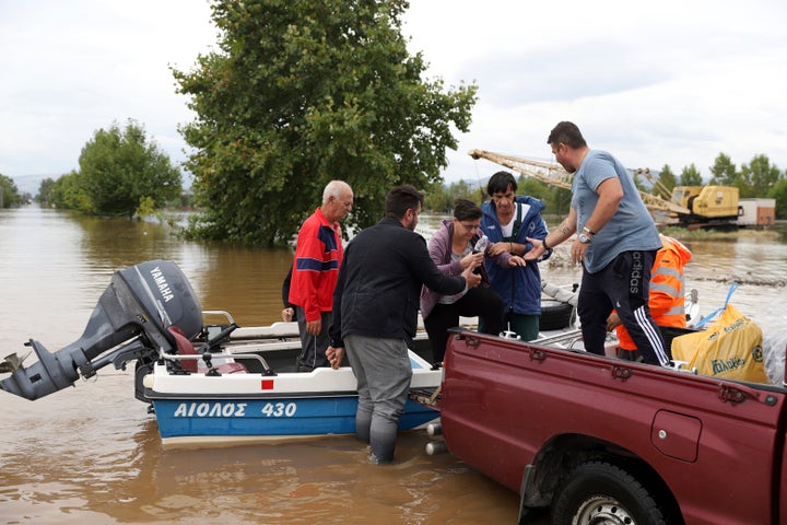 Local residents disembark from a small boat during an evacuee operation in the village of Farkadona, Thessaly region, central Greece, on Sept. 7, 2023. 