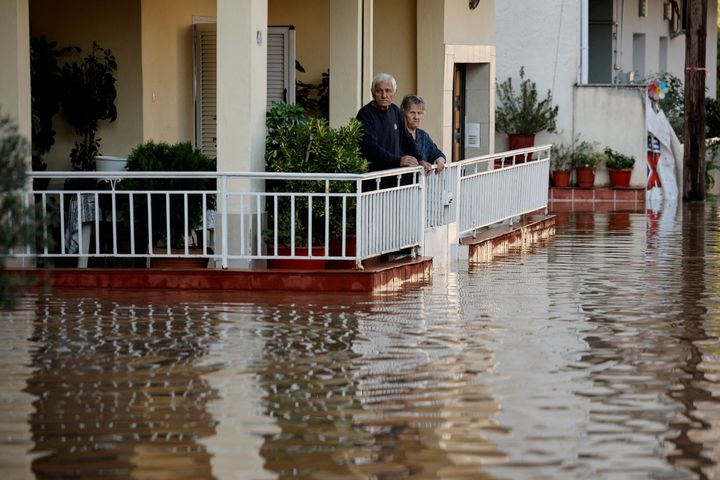 An elderly couple look from their partially flooded house, as the Pinios river over flooded after torrential rains in Larissa, Greece September 8, 2023. REUTERS/Louisa Gouliamaki TPX IMAGES OF THE DAY