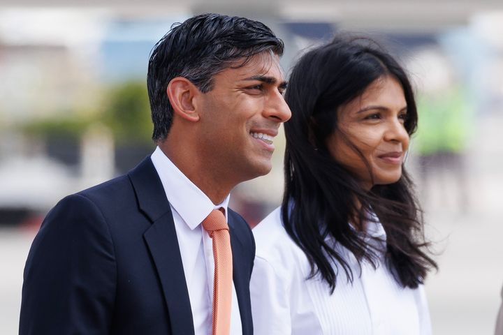 Rishi Sunak and his wife Akshata Murty are met on the tarmac by dignitaries as they arrive at Indira Gandhi Airport in India.