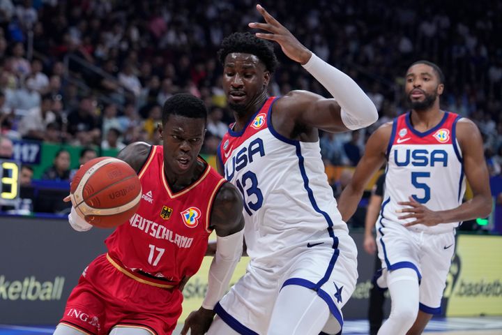 Germany guard Dennis Schroder, left, goes around U.S. forward Jaren Jackson Jr. during a Basketball World Cup semi final game in Manila, Philippines, Friday, Sept. 8, 2023. (AP Photo/Michael Conroy)