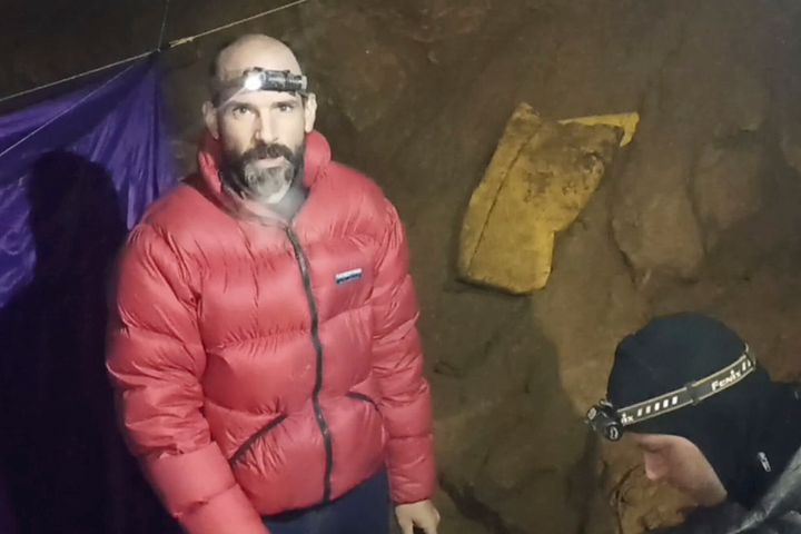 In this screenshot from video, American caver Mark Dickey, 40, talks to camera next to a colleague inside the Morca cave near Anamur, southern Turkey, on Sept. 7.