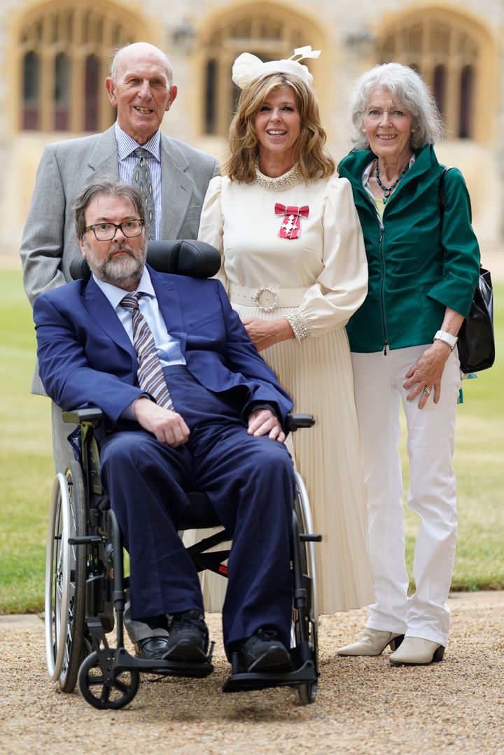 Kate with her parents and husband after receiving her MBE in June 2023