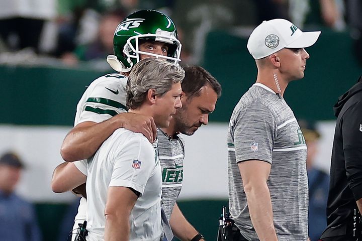 New York Jets quarterback Aaron Rodgers (8) is helped off the field during the first quarter of an NFL football game against the Buffalo Bills, Monday, Sept. 11, 2023, in East Rutherford, N.J.