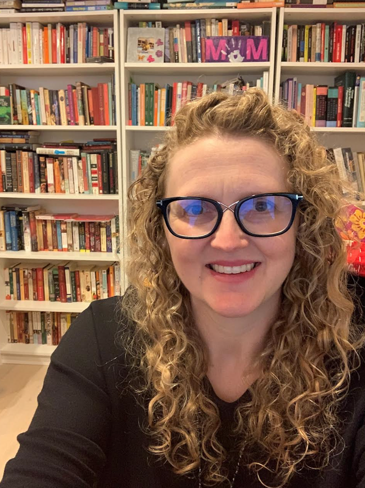 The author in her office with her books. "Note historical fiction take up several shelves!" she writes.