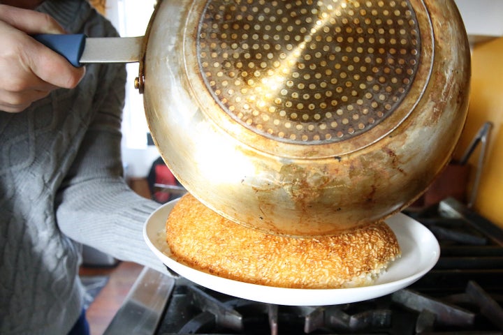 Tahdig is flipped onto a platter.