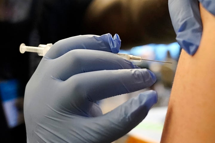 A person receives a Pfizer COVID-19 vaccine booster shot. The CDC recommends that everyone ages 6 months and up get the latest vaccine, which is designed to fight the most common variants of the virus that are currently circulating.