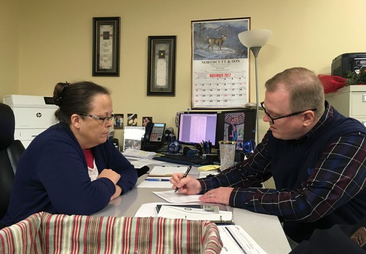 Kim Davis, a Former county clerk in Kentucky, pictured above above, has been ordered to pay $100,000 to the same-sex couple she refused to issue a marriage licenses for.