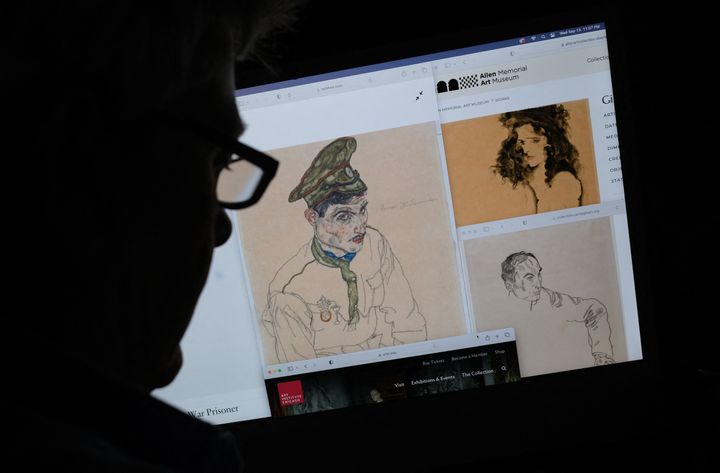 This photo illustration created in Los Angeles, California, on September 13, 2023, shows a person looking on a computer screen at artwork by Austrian Expressionist Egon Schiele entitled "Russian War Prisoner" (L), "Portrait of a Man" (R) and "Girl With Black Hair" (top), which were seized by investigators after the Manhattan district attorney's office issued warrants. US authorities seized three artworks sought by the heirs of a Jewish art collector who died in the Holocaust, officials said on September 14, 2023. They confirmed a story in The New York Times that said New York investigators had taken these works by the 1900s Austrian expressionist Egon Schiele from three museums throughout the country. In warrants issued September 12, 2023, and seen by AFP, the New York state supreme court said "there is reasonable cause to believe" the works constitute stolen property. (Photo by Chris DELMAS / AFP) / RESTRICTED TO EDITORIAL USE - MANDATORY MENTION OF THE ARTIST UPON PUBLICATION - TO ILLUSTRATE THE EVENT AS SPECIFIED IN THE CAPTION (Photo by CHRIS DELMAS/AFP via Getty Images)