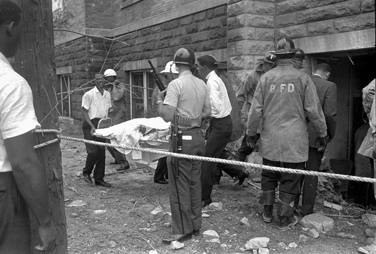 In this Sept. 15, 1963, file photo, firefighters and ambulance attendants remove a covered body from the 16th Street Baptist Church in Birmingham, Alabama, after members of the Ku Klux Klan set off a deadly explosion.