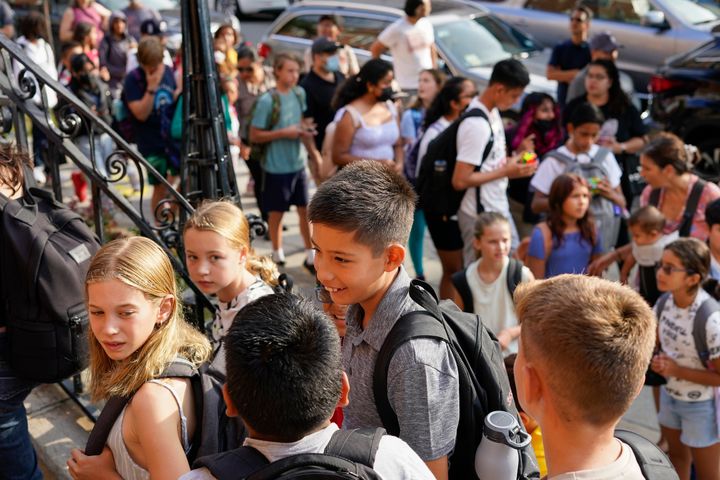 Students are lined up outside of the Adams' campus of Oyster Adams Bilingual School in August 2022 in Washington, D.C. Opponents of Republican-proposed government spending cuts say they would hurt programs to aid schools in low-income areas.