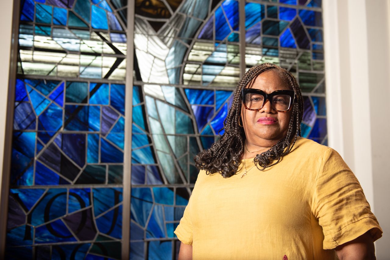 Lisa McNair stands in the balcony of the 16th Street Baptist Church in front of the Wales Window on Sept. 11, 2023. The Wales Window was installed in 1965 by the people of Wales after the original was destroyed in 1963 during the bombing.