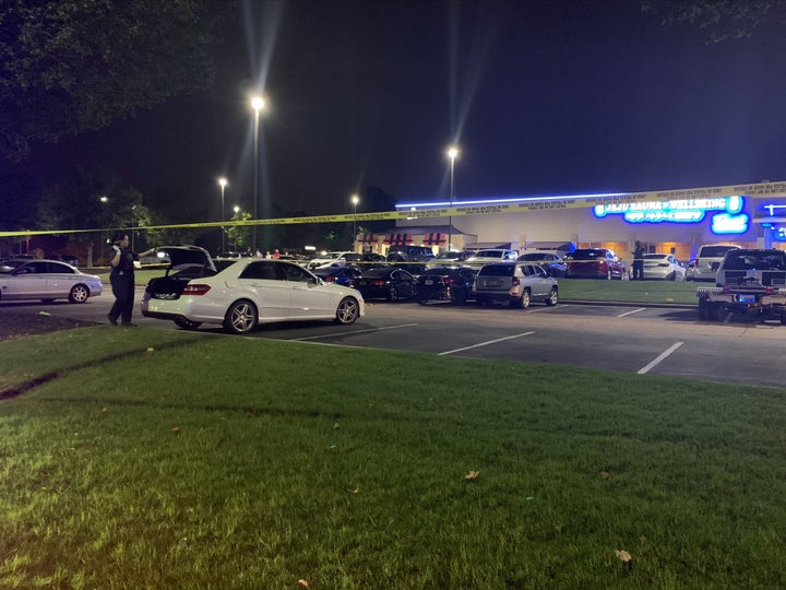 A police photo shows the parking lot where the woman's body was found inside a car trunk.