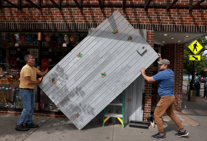 Mike (L) and Russ (who did not want to provide their last names) help place shutters over the windows at the Island Imports store before the possible arrival of Hurricane Lee on September 15, 2023 in Bar Harbor, Maine. Most of Maine is now in a Tropical Storm warning as Lee continues its path up the coastline. Forecasters say it will remain large and dangerous.