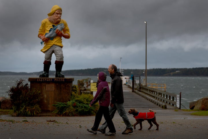 EASTPORT, Maine - SEPTEMBER 16: People walk as winds and rain from what was formerly Hurricane Lee and is now a post-tropical cyclone impact the area on September 16, 2023 in Eastport, Maine.  The storm's strength has been reduced, but meteorologists say it will remain large and dangerous.  (Photo by Joe Raedle/Getty Images)