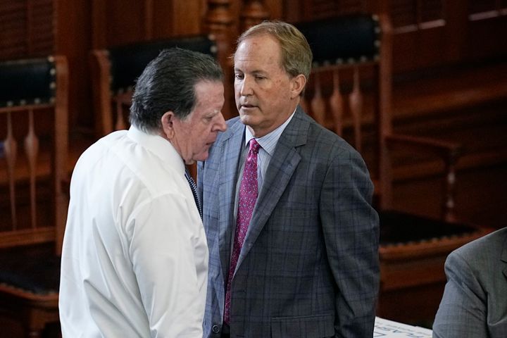 Suspended Texas state Attorney General Ken Paxton, right, talks with his attorney Dan Cogdell, left, during his impeachment trial in the Senate Chamber at the Texas Capitol, Friday, Sept. 15, 2023, in Austin, Texas. (AP Photo/Eric Gay)