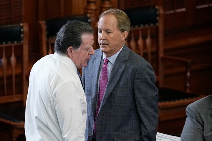 Suspended Texas state Attorney General Ken Paxton, right, talks with his attorney Dan Cogdell, left, during his impeachment trial in the Senate Chamber at the Texas Capitol, Friday, Sept. 15, 2023, in Austin, Texas. (AP Photo/Eric Gay)