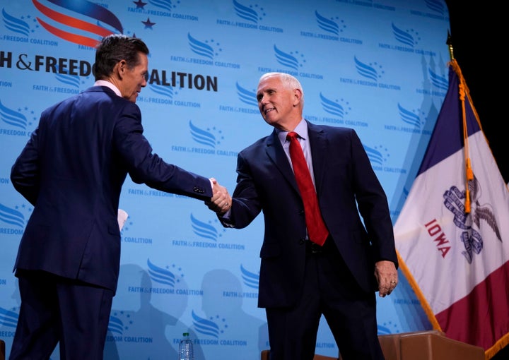 Republican presidential candidate and former Vice President Mike Pence, right, shakes the hand of Faith & Freedom Coalition founder and chairman Ralph Reed before speaking at the organizations' fall banquet, Saturday, Sept. 16, 2023, in Des Moines, Iowa. (AP Photo/Bryon Houlgrave)