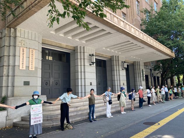市民が「ヒューマンチェーン（人間の鎖）」を作って文部科学省を囲み、神宮外苑の再開発に抗議した