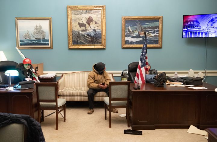 Trump supporters in Nancy Pelosi's office suite after breaching the U.S. Capitol on Jan. 6, 2021.