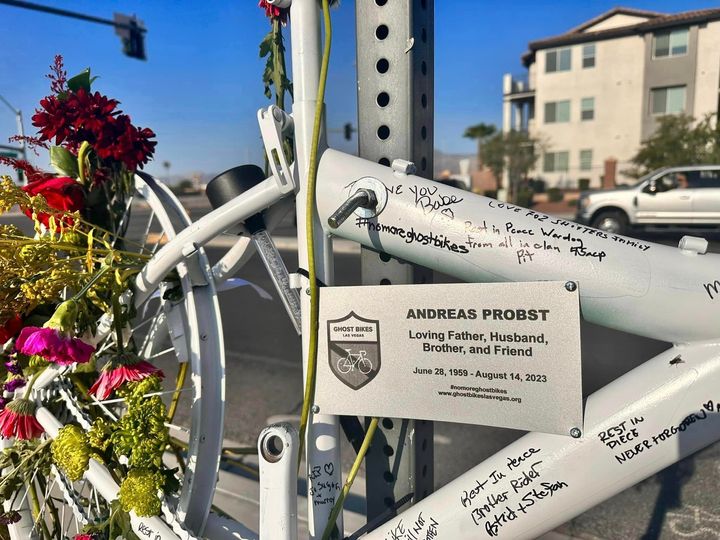 Mourners signed the frame of a bike at a memorial for Andreas Probst near the site where he was struck in Las Vegas.