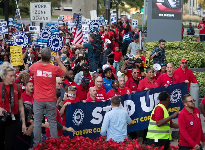 United Auto Workers members march in Detroit following their decision to go on strike on Friday. The strike is the first time in history that the union has targeted all three Detroit automakers at once.