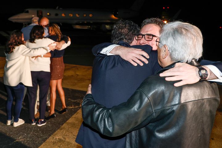Family members embrace freed Americans Siamak Namazi, Morad Tahbaz and Emad Shargi, as well as two returnees whose names have not yet been released by the U.S. government, who were released in a prisoner swap deal between U.S and Iran, as they arrive at Davison Army Airfield, on Sept. 19, 2923 at Fort Belvoir, Va.