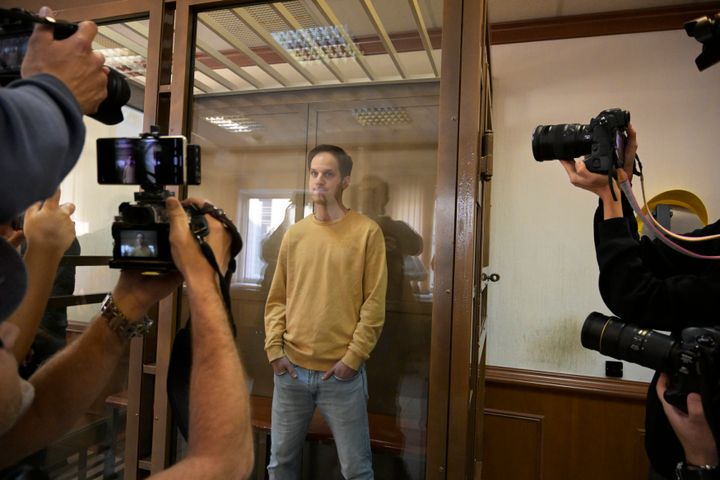 Wall Street Journal reporter Evan Gershkovich stands in a glass cage in a courtroom at the Moscow City Court, in Moscow, Russia, on Sept. 19, 2023.
