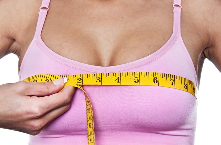 woman checking her breast measurement for fit bra size Stock Photo