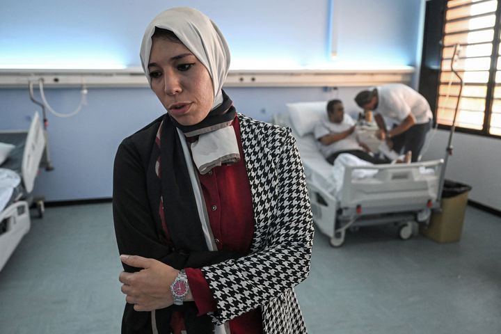 Dr. Fadwa el-Fartass, a medical officer at the Benghazi Medical Centre hospital, speaks at a ward with survivors of the recent flooding in Libya's eastern city of Derna, on September 18, 2023. More than a week after the deadly flash floods that hit a coastal city in Libya, survivors want answers why the calls to repair the two dams that collapsed after the storm "Daniel" went unheeded and who will help them in case of an epidemic.