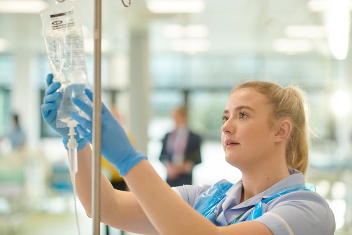 student nurse adjusting IV