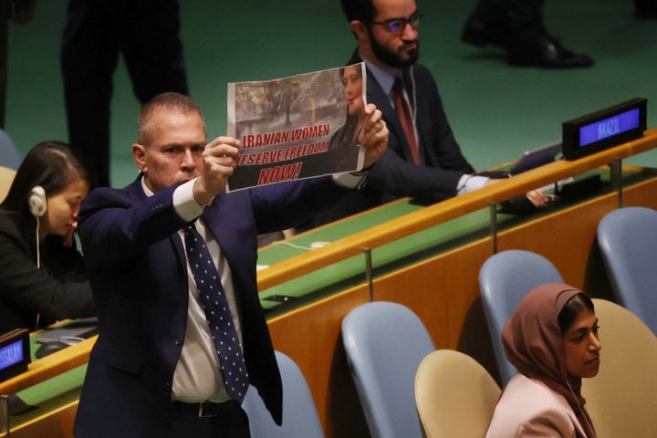 Gilad Erdan holds up a sign stating 'Iranian Women Deserve Freedom Now' seconds after Iran's President Ebrahim Raisi began addressing world leaders during the United Nations (UN) General Assembly