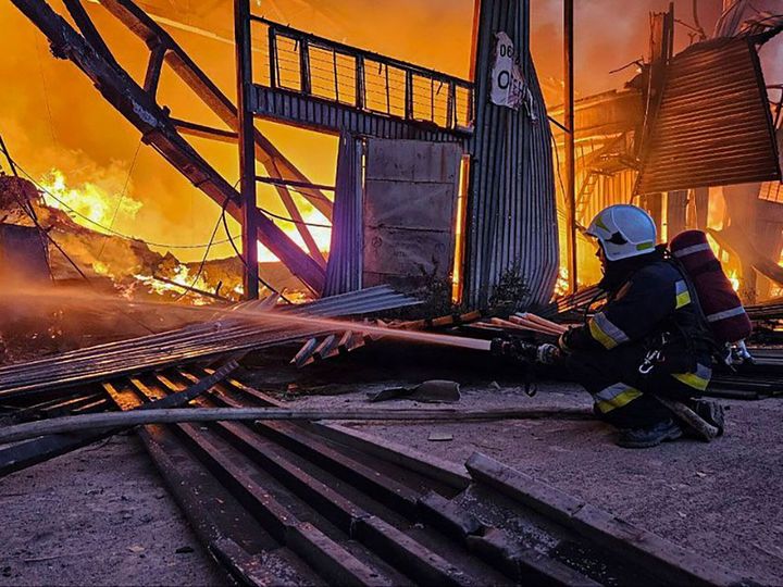 In this photo provided by the Ukrainian Emergency Service, emergency services personnel work to extinguish a fire following a Russian attack in Lviv, Ukraine, Tuesday, Sept. 19, 2023. 