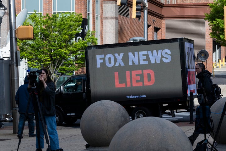 A truck drives by with a display reading "Fox News LIED" on the first day of the Dominion v. Fox trial in Wilmington, Delaware, on April 18, 2023.