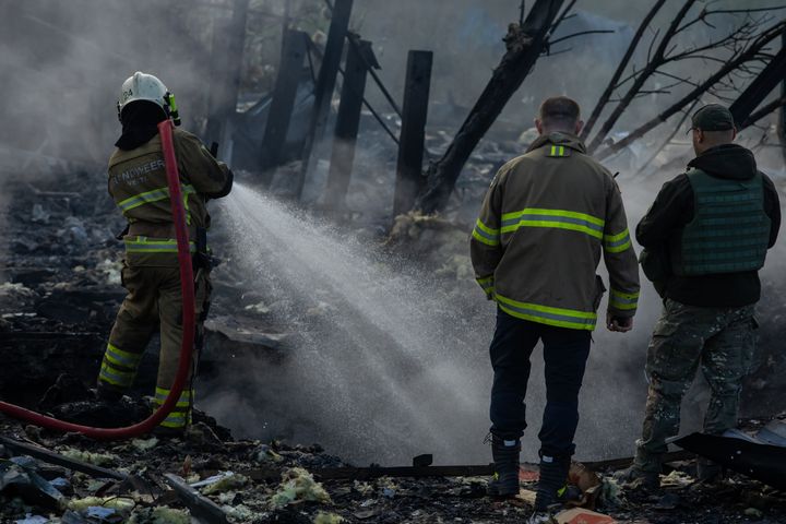 Firefighters extinguish a blaze at an industrial area after a missile attack Thursday in Kyiv, Ukraine.