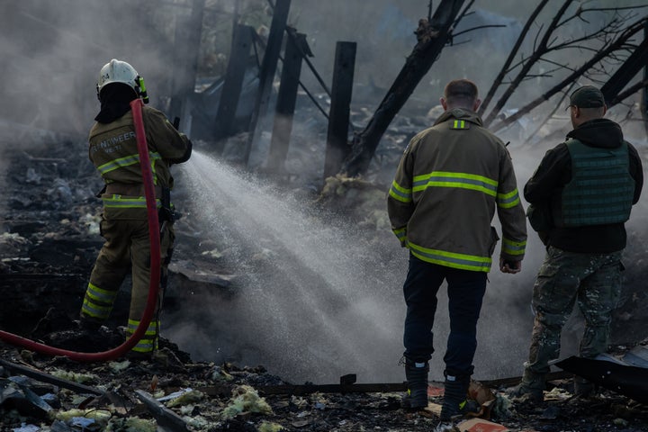 Firefighters extinguish a blaze at an industrial area after a missile attack Thursday in Kyiv, Ukraine.