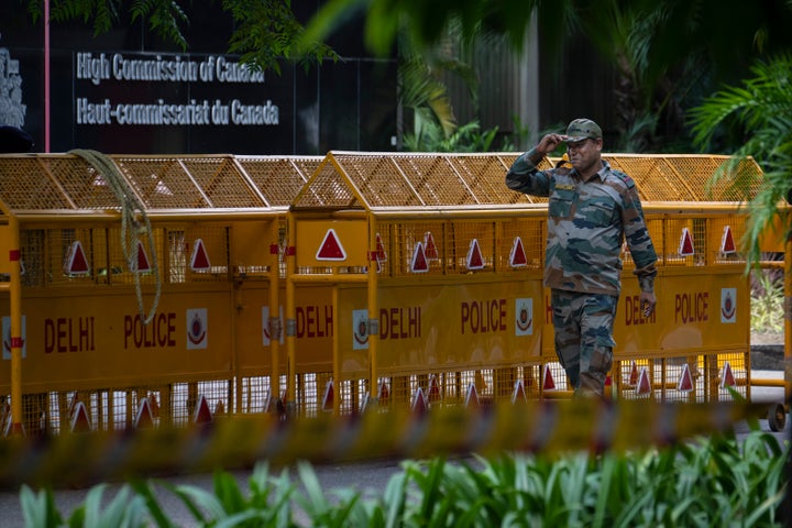 An Indian paramilitary soldier stands guard next to a police barricade outside the Canadian High Commission in New Delhi, India, Tuesday, Sept. 19, 2023. Tensions between India and Canada are high after Prime Minister Justin Trudeau's government expelled a top Indian diplomat and accused India of having links to the assassination in Canada of Sikh leader Hardeep Singh Nijjar, a strong supporter of an independent Sikh homeland. (AP Photo/Altaf Qadri)