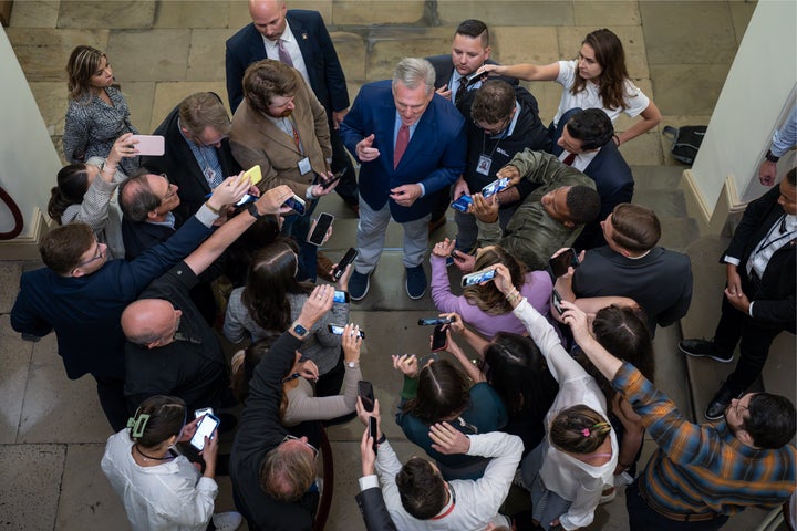 Speaker of the House Kevin McCarthy, R-Calif., is surrounded by reporters looking for updates on plans to fund the government and avert a shutdown, at the Capitol in Washington, Friday, Sept. 22, 2023. (AP Photo/J. Scott Applewhite)