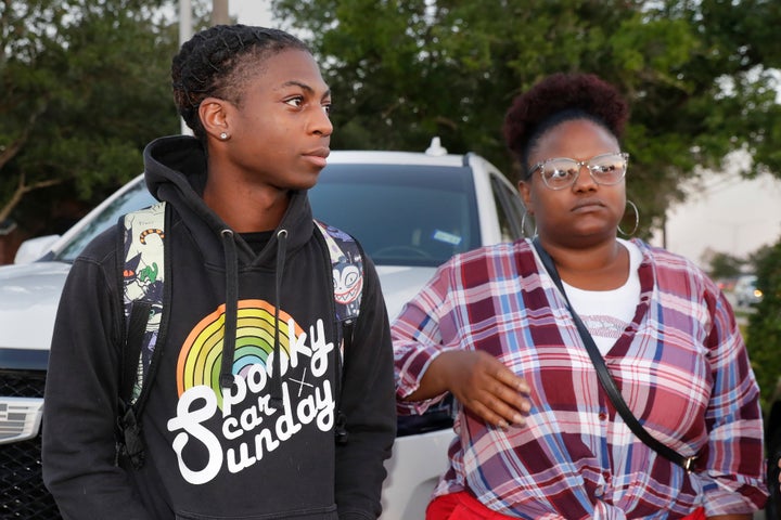 Darryl George, left, a 17-year-old junior, and his mother Darresha George, right, talks with reporters before walking across the street to go into Barbers Hill High School after Darryl served a 5-day in-school suspension for not cutting his hair Monday, Sept. 18, 2023, in Mont Belvieu. (AP Photo/Michael Wyke)